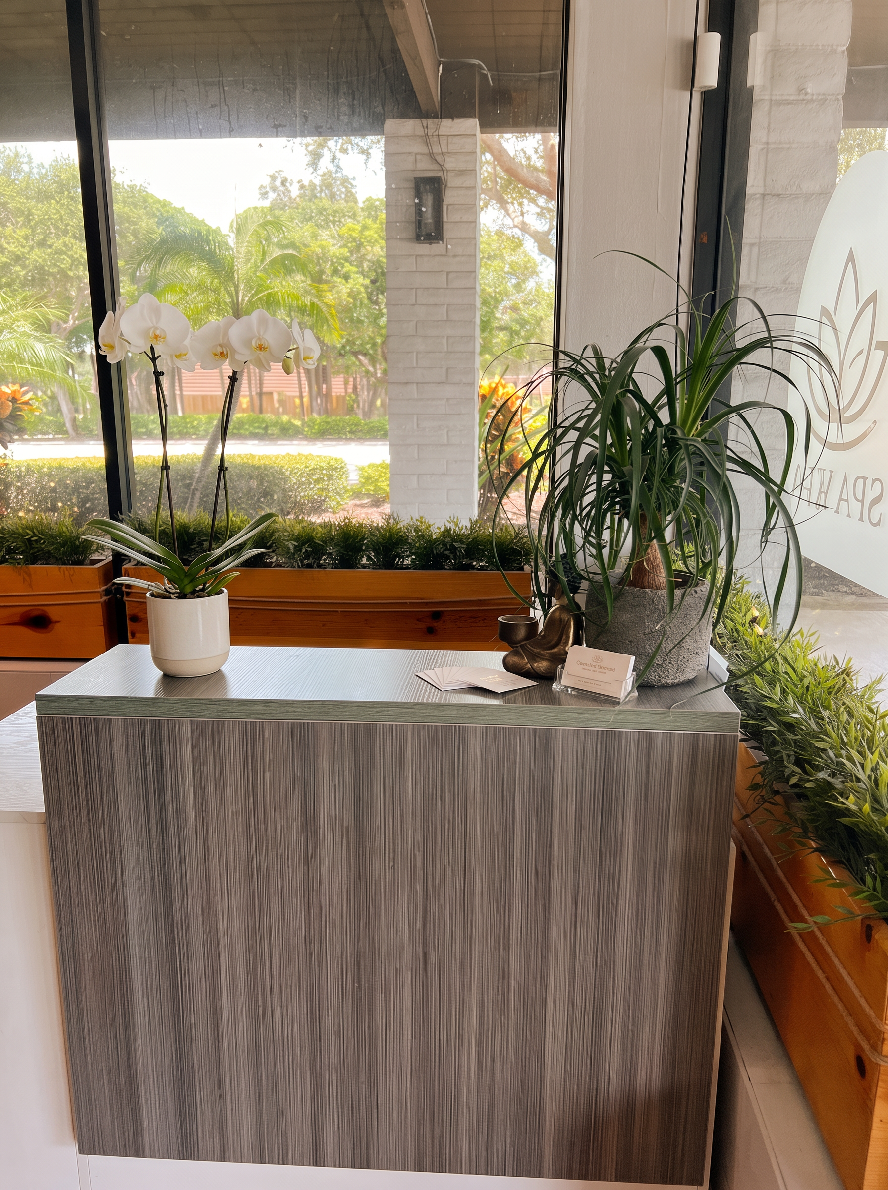 Reception desk with orchid and greenery at Garden Square Nails & Spa